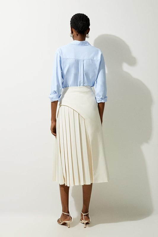 Feel elegant in our midi skirt, with a universally flattering silhouette, pleated detailing, and a high waistline, perfect for getting a little dressed up. Style this piece with strappy heels for an outfit that will turn heads from office days to upcoming occasions and events. Tailored Buckle Detail Pleated Midi Skirt Formal, Flowing Fit High Waistline Unique Pleated Panel Midi Length Metallic Buckle at WaistlineBrowse this seasons work skirts or discover the full range of workwear now.
