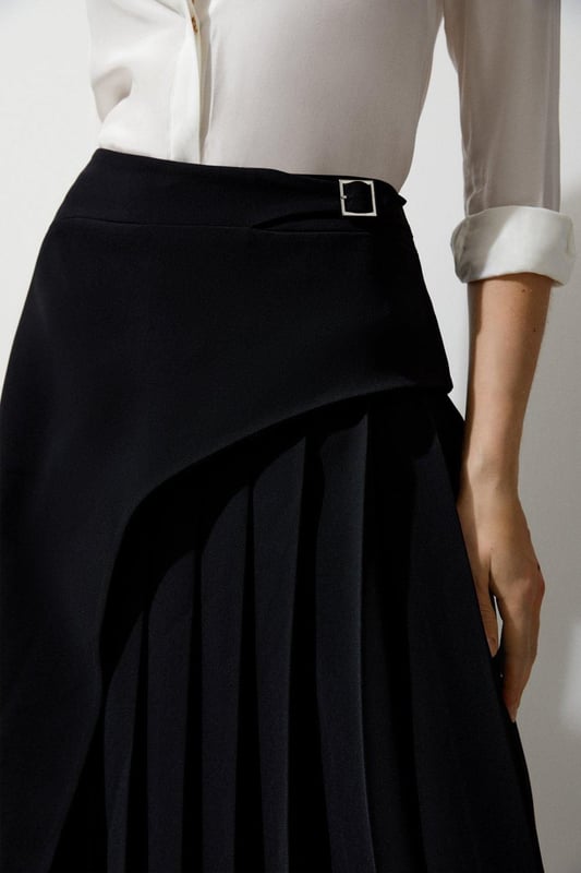 Feel elegant in our midi skirt, with a universally flattering silhouette, pleated detailing, and a high waistline, perfect for getting a little dressed up. Style this piece with strappy heels for an outfit that will turn heads from office days to upcoming occasions and events. Tailored Buckle Detail Pleated Midi Skirt Formal, Flowing Fit High Waistline Unique Pleated Panel Midi Length Metallic Buckle at WaistlineBrowse this seasons work skirts or discover the full range of workwear now.