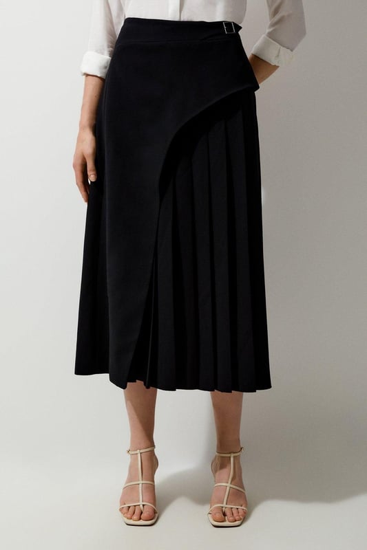 Feel elegant in our midi skirt, with a universally flattering silhouette, pleated detailing, and a high waistline, perfect for getting a little dressed up. Style this piece with strappy heels for an outfit that will turn heads from office days to upcoming occasions and events. Tailored Buckle Detail Pleated Midi Skirt Formal, Flowing Fit High Waistline Unique Pleated Panel Midi Length Metallic Buckle at WaistlineBrowse this seasons work skirts or discover the full range of workwear now.