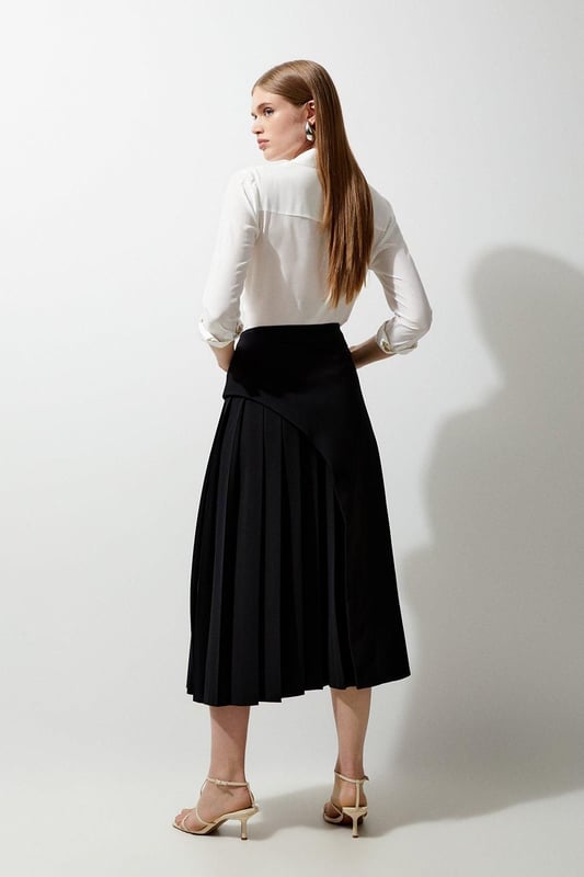 Feel elegant in our midi skirt, with a universally flattering silhouette, pleated detailing, and a high waistline, perfect for getting a little dressed up. Style this piece with strappy heels for an outfit that will turn heads from office days to upcoming occasions and events. Tailored Buckle Detail Pleated Midi Skirt Formal, Flowing Fit High Waistline Unique Pleated Panel Midi Length Metallic Buckle at WaistlineBrowse this seasons work skirts or discover the full range of workwear now.