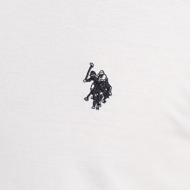 Inspirado en la herencia deportiva de la marca, este polo U.S. Polo Assn. ofrece una combinación perfecta de tradición y modernidad. Diseñado para el hombre que valora la autenticidad, su corte impecable y sus detalles bordados lo convierten en una prenda esencial del armario contemporáneo.

Detalles:
- Cuello clásico tipo polo con tapeta de dos botones.
- Mangas cortas.
- Detalle de ribete en el interior del cuello.
- Logo U.S. Polo Assn. bordado en el pecho.
- Corte regular que garantiza comodidad y libertad de movimiento.
- Tejido de piqué transpirable de alta calidad.

En U.S. Polo Assn., cada prenda cuenta una historia de autenticidad, tradición y estilo deportivo. Este polo hombre no es solo una prenda básica: representa el legado oficial del deporte del polo y refleja nuestra pasión por la calidad, el diseño y la elegancia casual. Viste con identidad, viste con historia.
 Composición: 100% Algodón
 Cuidados:
Lavar a máquina en frío (máx. 30 °C).
No usar lejía.
Planchar a temperatura baja si es necesario.
Secar al aire, evitar secadora.
