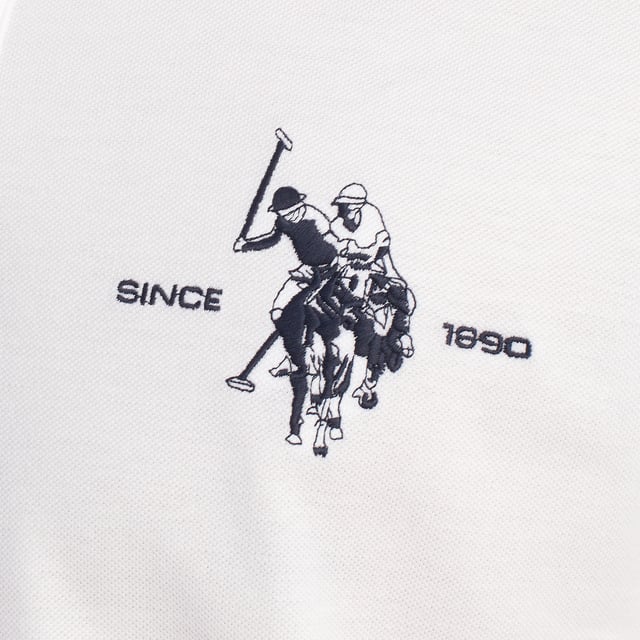 Inspired by the brand's sporting heritage, this US Polo Assn. polo offers a perfect blend of tradition and modernity. Designed for the man who values authenticity, its impeccable cut and embroidered details make it a contemporary wardrobe staple.

 Details:
 - Classic polo-style collar with two-button placket.
 - Short sleeves.
 - Tricolor trim detail on the inside of the neck.
 - US Polo Assn. logo embroidered on the chest with “Since 1890” inscription.
 - Regular cut that guarantees comfort and freedom of movement.
 - High quality breathable piqué fabric.

 At US Polo Assn., every garment tells a story of authenticity, tradition, and sporty style. This men's polo shirt isn't just a staple: it represents the official heritage of the sport of polo and reflects our passion for quality, design, and casual elegance. Dress with identity, dress with history.
 Composition: 100% Cotton
 Care:
Machine wash cold (max. 30°C).
 Do not use bleach.
 Iron at low temperature if necessary.
 Air dry, avoid dryer.
