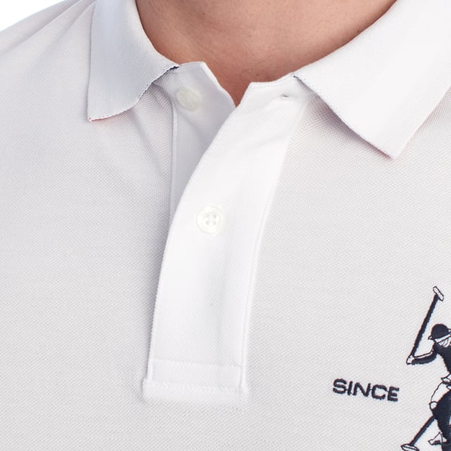 Inspired by the brand's sporting heritage, this US Polo Assn. polo offers a perfect blend of tradition and modernity. Designed for the man who values authenticity, its impeccable cut and embroidered details make it a contemporary wardrobe staple.

 Details:
 - Classic polo-style collar with two-button placket.
 - Short sleeves.
 - Tricolor trim detail on the inside of the neck.
 - US Polo Assn. logo embroidered on the chest with “Since 1890” inscription.
 - Regular cut that guarantees comfort and freedom of movement.
 - High quality breathable piqué fabric.

 At US Polo Assn., every garment tells a story of authenticity, tradition, and sporty style. This men's polo shirt isn't just a staple: it represents the official heritage of the sport of polo and reflects our passion for quality, design, and casual elegance. Dress with identity, dress with history.
 Composition: 100% Cotton
 Care:
Machine wash cold (max. 30°C).
 Do not use bleach.
 Iron at low temperature if necessary.
 Air dry, avoid dryer.