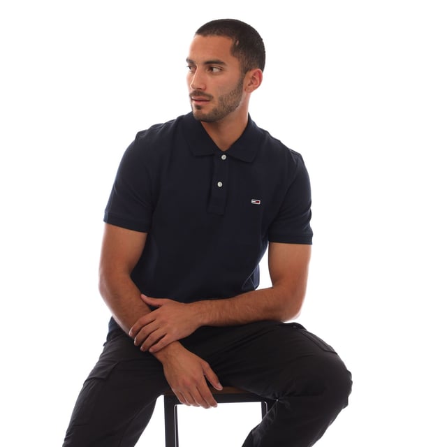 Mens Tommy Jeans Casual Polo Shirt in navy.- Ribbed polo collar.- Short sleeves with ribbed cuffs.- Two button placket.- Tommy Hilfiger flag embroidery on chest.- Split hem.- Regular fit.- 100% Cotton.- Ref.: DM0DM20763C1G