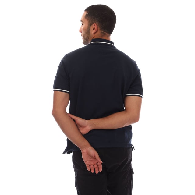 Mens Tommy Jeans Regular Fit Tipped Polo Shirt in navy.- Ribbed polo collar.- Two button placket.- Short sleeves with ribbed cuffs.- Contrast tipping at collar and cuffs- Embroidered Tommy Jeans flag patch at left chest.- Even vented hem.- Soft and comfortable cotton piqué fabric  made with at least 95% regenerative cotton.- Regular fit.- 100% Cotton.  Machine washable.- Ref: DM0DM20745C1G