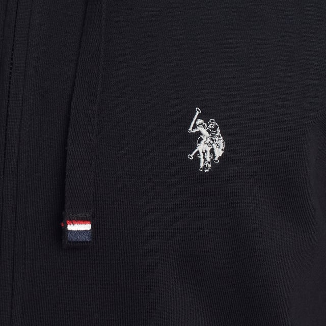Designed for those who value functionality without sacrificing style, this US Polo Assn. zip-up hoodie combines comfort, contemporary design, and sporting heritage. Ideal for casual looks or light workouts, it adapts to the pace of everyday life with a timeless aesthetic.

 Details:
 - Full zip front closure.
 - Hood with adjustable contrasting drawstring.
 - Round neck.
 - Functional kangaroo pockets.
 - US Polo Assn. logo embroidered on the chest.
 - Soft and stretchy fabric, ideal for everyday use.
 - Ribbed cuffs and waistband.
 - Matching visible seams.

 At US Polo Assn., every garment reflects the authentic spirit of the sport of polo. This men's sweatshirt represents our commitment to quality, comfort, and classic style reinvented for the modern man.
 Composition: 100% Cotton
 Care:
Wash at maximum temperature 30º.
 Iron at low temperature.
 Do not use bleach.
 Do not use a dryer.
 Do not dry clean.