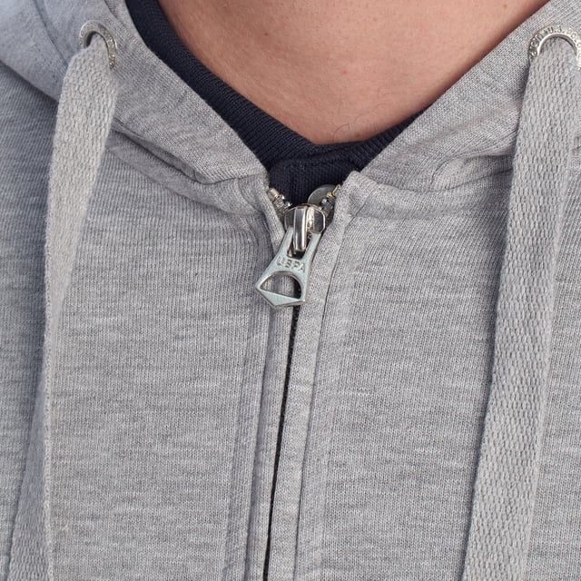 Designed for those who value functionality without sacrificing style, this US Polo Assn. zip-up hoodie combines comfort, contemporary design, and sporting heritage. Ideal for casual looks or light workouts, it adapts to the pace of everyday life with a timeless aesthetic.

 Details:
 - Full zip front closure.
 - Hood with adjustable contrasting drawstring.
 - Round neck.
 - Functional kangaroo pockets.
 - US Polo Assn. logo embroidered on the chest.
 - Soft and stretchy fabric, ideal for everyday use.
 - Ribbed cuffs and waistband.
 - Matching visible seams.

 At US Polo Assn., every garment reflects the authentic spirit of the sport of polo. This men's sweatshirt represents our commitment to quality, comfort, and classic style reinvented for the modern man.
 Composition: 100% Cotton
 Care:
Wash at maximum temperature 30º.
 Iron at low temperature.
 Do not use bleach.
 Do not use a dryer.
 Do not dry clean.