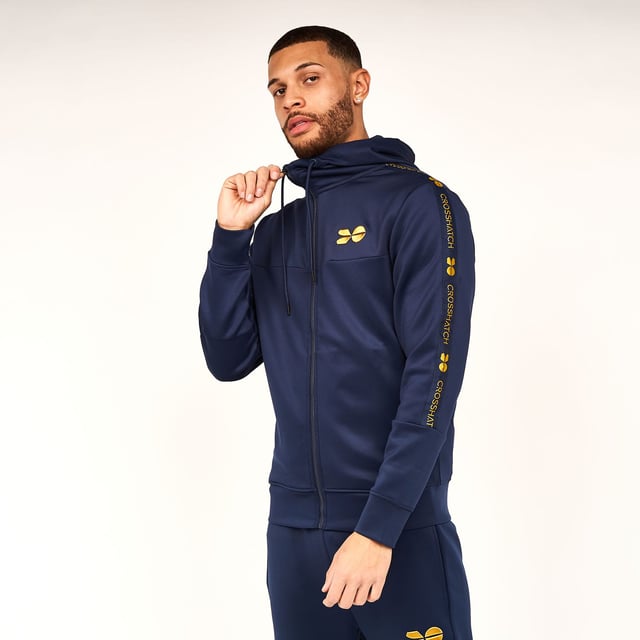 Mens Crosshatch Trackside Tracksuit in navy blueTrack top:- Drawcord-adjustable lined hood- Full zip fastening- Embroidered logo at left chest- Branded tape at sleeves- Side pocketsTrack pants:- Elasticated waist with drawcord- Side pockets- Rear pocket- Embroidered logo at left thigh- Branded tape at lower legs- 95% Polyester  5% Elastane.  Machine washable.- Ref: CH2Z119856AABLPlease note this style is sold as a set.  Returns will only be accepted if both items are returned together.