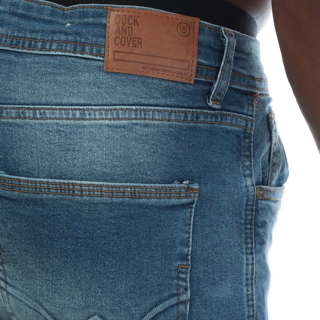Mens Duck and Cover Doves Slim Fit Jeans in mid wash blue denim. - Classic 5-pocket construction. - Zip fly and button fastening. - Branded back waist patch.- Slim fit. - Short inside leg length approx. 30in  Regular inside leg length approx. 32in  Long inside length approx. 34in.- 98% Cotton  2% Elastane. Machine washable. - Ref: DC2B122666MWMeasurements are intended for guidance only.