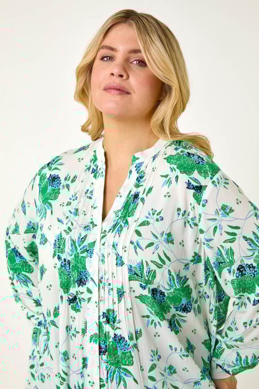 Curve Floral Print Pintuck Blouse from Roman. Add a touch of floral charm to your Spring Summer wardrobe with this gorgeous Curve pintuck blouse. The smart v-neckline and intricate pintuck detail create an elegant look. Crafted from a comfortable crinkle woven fabric in a beautiful floral print, this blouse features long sleeves and front buttons. Perfect for everyday wear, style with a denim jacket and jeggings for a completely stylish outfit!