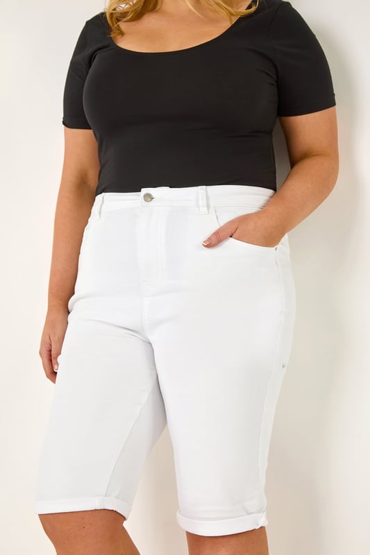 Curve Stretch Knee Length Denim Shorts from Roman. Give your Summer wardrobe a revamp with our new and improved knee length shorts. An essential for any ladies wardrobe, these long length Curve shorts have a comfortable stretch and a turned up hem for those warmer days. Secured to the front with a button and fly fastening, these denim favourites are finished with pocket detail to front and back. Make sure to pack yours in your holiday suitcase, team with your favourite printed or plain tees and sandals for a warm weather look.
