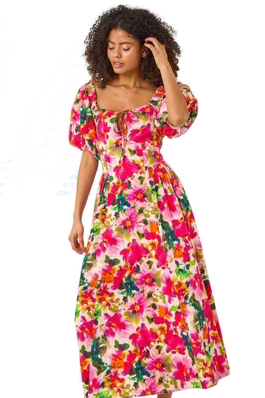 Dusk Floral Pleated Puff Dress from Roman. Feel chic and feminine in this floral puff dress, perfect for the Spring/Summer season. Featuring a flattering tie detail at the bust and cute short puff sleeves, this dress is designed in a stylish fit. Made from a comfortable woven fabric, it's a pull-on style for effortless wearing. Pair with sandals and sunglasses for a delightful outfit that's ideal for sunny days out!