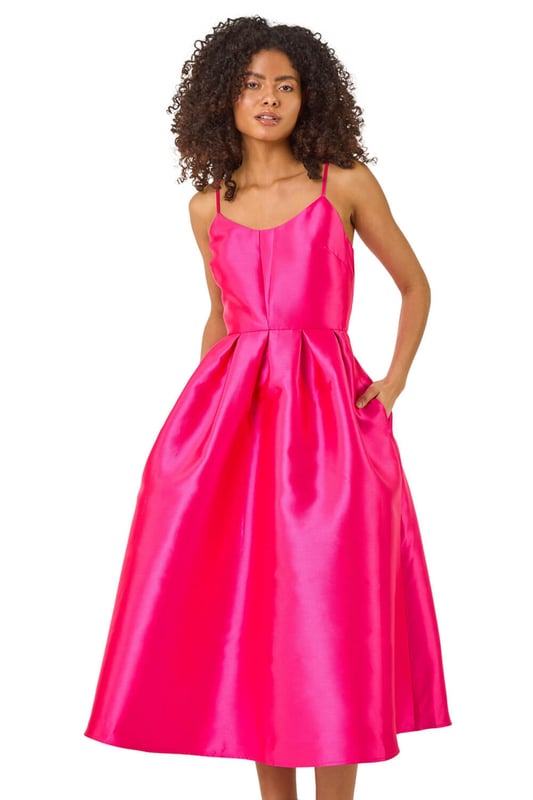 Dusk Twill Cami Pleated Midi Dress from Roman. Unleash your inner beauty in this luxurious satin cami dress, perfect for Spring and Summer. The twill fabric effortlessly falls into a flattering midi length with a pleated skirt detail, while the delicate cami straps add a touch of elegance. Complete the look with a bolero and heels for a sophisticated outfit destined to turn heads at any event!