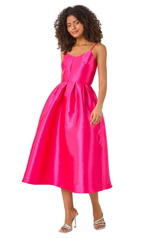 Dusk Twill Cami Pleated Midi Dress from Roman. Unleash your inner beauty in this luxurious satin cami dress, perfect for Spring and Summer. The twill fabric effortlessly falls into a flattering midi length with a pleated skirt detail, while the delicate cami straps add a touch of elegance. Complete the look with a bolero and heels for a sophisticated outfit destined to turn heads at any event!
