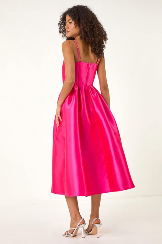 Dusk Twill Cami Pleated Midi Dress from Roman. Unleash your inner beauty in this luxurious satin cami dress, perfect for Spring and Summer. The twill fabric effortlessly falls into a flattering midi length with a pleated skirt detail, while the delicate cami straps add a touch of elegance. Complete the look with a bolero and heels for a sophisticated outfit destined to turn heads at any event!