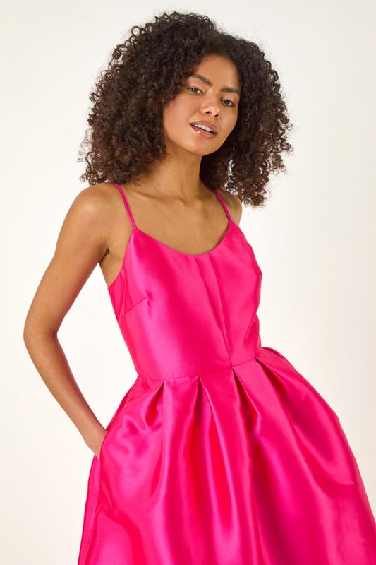 Dusk Twill Cami Pleated Midi Dress from Roman. Unleash your inner beauty in this luxurious satin cami dress, perfect for Spring and Summer. The twill fabric effortlessly falls into a flattering midi length with a pleated skirt detail, while the delicate cami straps add a touch of elegance. Complete the look with a bolero and heels for a sophisticated outfit destined to turn heads at any event!