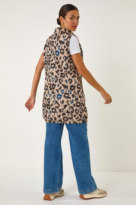 Animal Print Hooded Gilet from Roman. Stay stylish and on-trend this Spring Summer with this animal print hooded gilet in a longline silhouette. The eye-catching animal print adds a wild twist to this quilted piece, featuring a zip and practical zip pockets at the front. The gilet boasts a cosy funnel neck and a drawcord hood. Layer it over your favourite shirt and jeggings for a fashionable look that's versatile and perfect for the season!