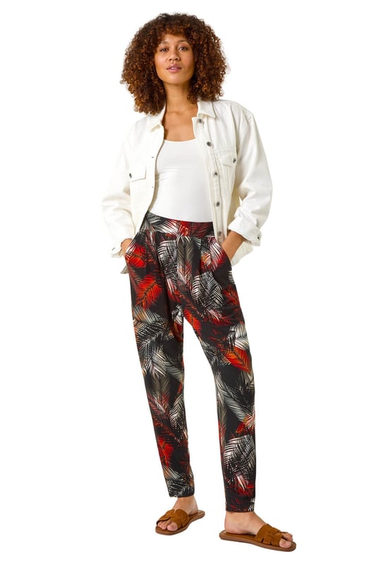 Leaf Print Harem Trouser from Roman. Embrace the tropical vibes with these leaf print harem trousers. Designed with an all over print, these trousers feature two front pockets and offer a comfortable, full-length fit. Pair with a simple cami top and sandals for a laid-back and stylish Spring/Summer look that's perfect for any casual outing!