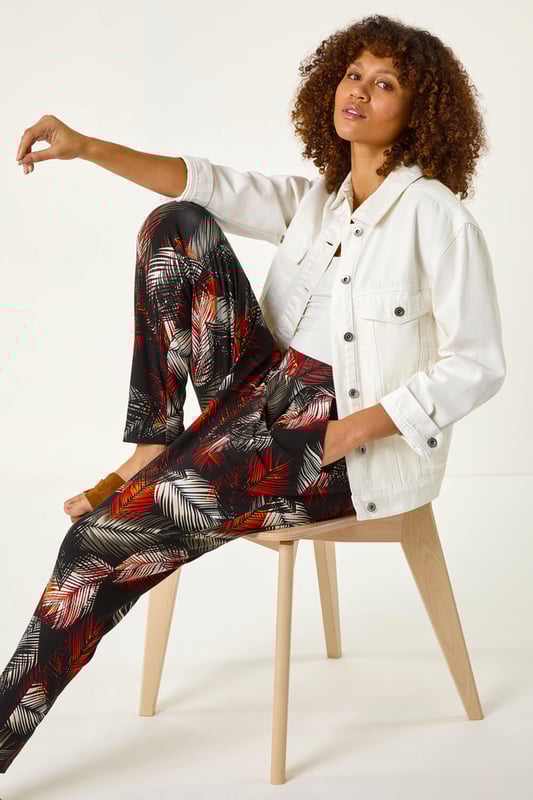 Leaf Print Harem Trouser from Roman. Embrace the tropical vibes with these leaf print harem trousers. Designed with an all over print, these trousers feature two front pockets and offer a comfortable, full-length fit. Pair with a simple cami top and sandals for a laid-back and stylish Spring/Summer look that's perfect for any casual outing!