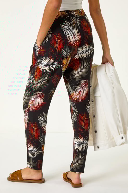 Leaf Print Harem Trouser from Roman. Embrace the tropical vibes with these leaf print harem trousers. Designed with an all over print, these trousers feature two front pockets and offer a comfortable, full-length fit. Pair with a simple cami top and sandals for a laid-back and stylish Spring/Summer look that's perfect for any casual outing!