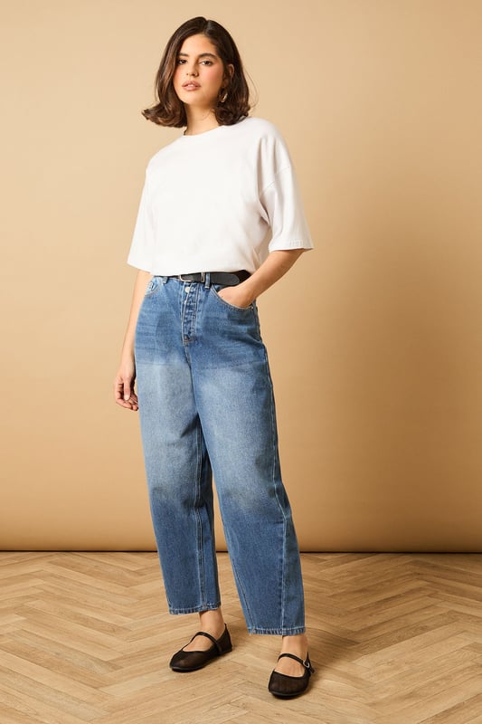 Trendy barrel leg silhouette for a modern twist on classic denim
        High-rise waist for a flattering and comfortable fit
        Tapered design from thigh to ankle for a stylish shape
        Traditional five-pocket styling for practicality
        Button and zip fly fastening for secure wear
    
    Embrace the latest denim trend with these chic barrel leg jeans from Oasis. The high-rise waist and tapered silhouette create a flattering shape that's perfect for various body types. Style these versatile jeans for a range of casual occasions - pair them with a cropped white tee and denim jacket for a double denim look that's effortlessly cool. For a more polished ensemble, team with a silky blouse and metallic flats. These jeans are ideal for family gatherings, weekend brunches, or casual Fridays at the office. The relaxed fit through the thigh transitioning to a slightly narrower ankle offers both comfort and style, making these jeans a wardrobe staple that you'll reach for time and time again.