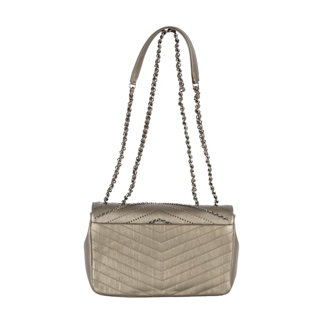 From Fall/Winter 2018 collection, the Chevron Flap Bag by Chanel is made of calfskin leather in metallic silver which gives a glittering appearance and intriguing texture. It features embelished chains woven with leather straps and tiny sequin studs that creates the Chevron pattern in the center. The shoulder strap is decorated with the woven chain as well as leather strap for the ease of carrying over the shoulder. 
Remarks: Sticker on the CC logo-ed metal clasp is still intact.
Inclusion: Dust bag, box, authentication card.
NFT option available. Discover more.
Assured Product Authenticity: This product is supplied by a renowned and trusted partner.
With this purchase, you are preserving iconic craftsmanship, celebrating heritage, and embracing the beauty of conscious shopping. Measurments:  width: 610 mm height: 381 mm