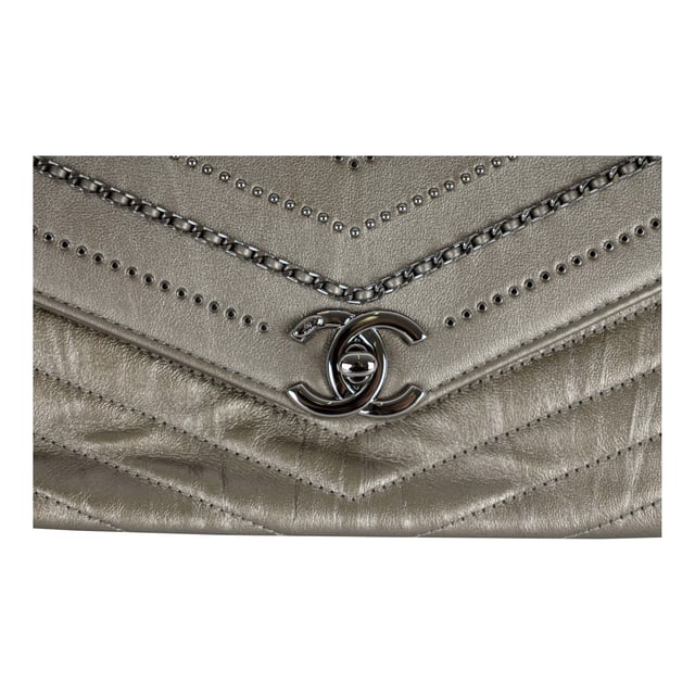 From Fall/Winter 2018 collection, the Chevron Flap Bag by Chanel is made of calfskin leather in metallic silver which gives a glittering appearance and intriguing texture. It features embelished chains woven with leather straps and tiny sequin studs that creates the Chevron pattern in the center. The shoulder strap is decorated with the woven chain as well as leather strap for the ease of carrying over the shoulder. 
Remarks: Sticker on the CC logo-ed metal clasp is still intact.
Inclusion: Dust bag, box, authentication card.
NFT option available. Discover more.
Assured Product Authenticity: This product is supplied by a renowned and trusted partner.
With this purchase, you are preserving iconic craftsmanship, celebrating heritage, and embracing the beauty of conscious shopping. Measurments:  width: 610 mm height: 381 mm