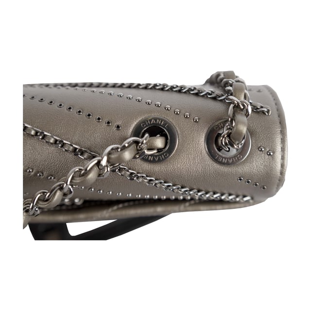 From Fall/Winter 2018 collection, the Chevron Flap Bag by Chanel is made of calfskin leather in metallic silver which gives a glittering appearance and intriguing texture. It features embelished chains woven with leather straps and tiny sequin studs that creates the Chevron pattern in the center. The shoulder strap is decorated with the woven chain as well as leather strap for the ease of carrying over the shoulder. 
Remarks: Sticker on the CC logo-ed metal clasp is still intact.
Inclusion: Dust bag, box, authentication card.
NFT option available. Discover more.
Assured Product Authenticity: This product is supplied by a renowned and trusted partner.
With this purchase, you are preserving iconic craftsmanship, celebrating heritage, and embracing the beauty of conscious shopping. Measurments:  width: 610 mm height: 381 mm
