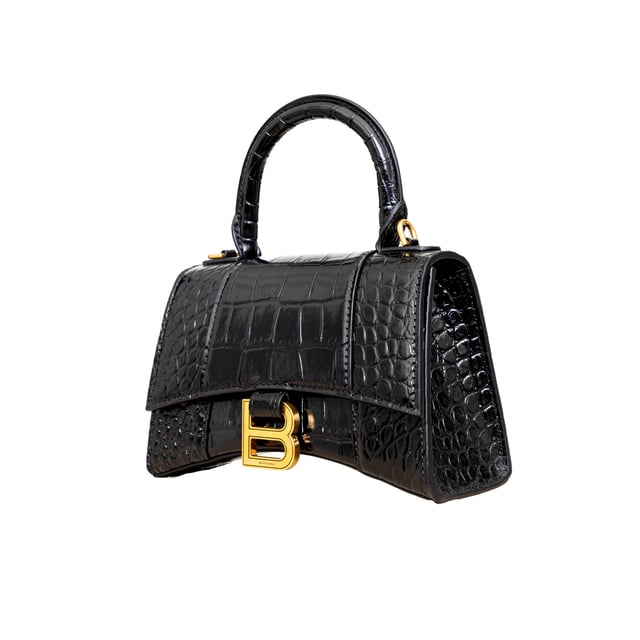VINTAGE, RRP AS NEW
Crafted from black, shiny crocodile embossed calfskin, this Balenciaga handbag in XS format features the iconic curvilinear base, one top handle, and a studded magnet closure for a chic and modern touch. The aged-gold B logo hardware and nappa lambskin lining add a touch of sophistication, while the back and inner pockets and the removable shoulder strap make the bag more functional.
Inclusion: dust bag, shoulder strap.
NFT option available. Discover more.
Assured Product Authenticity: This product is supplied by a renowned and trusted partner.
With this purchase, you are preserving iconic craftsmanship, celebrating heritage, and embracing the beauty of conscious shopping.Measurments:  width: 165 mm length: 457 mm height: 300 mm handle drop: 165 mm