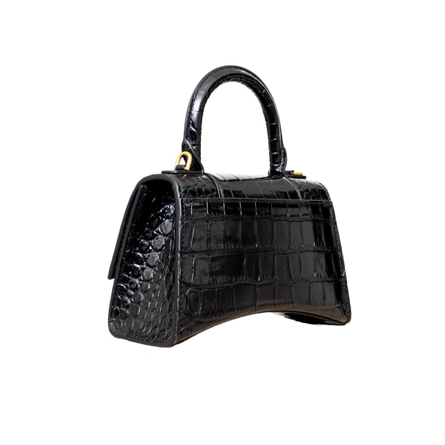 VINTAGE, RRP AS NEW
Crafted from black, shiny crocodile embossed calfskin, this Balenciaga handbag in XS format features the iconic curvilinear base, one top handle, and a studded magnet closure for a chic and modern touch. The aged-gold B logo hardware and nappa lambskin lining add a touch of sophistication, while the back and inner pockets and the removable shoulder strap make the bag more functional.
Inclusion: dust bag, shoulder strap.
NFT option available. Discover more.
Assured Product Authenticity: This product is supplied by a renowned and trusted partner.
With this purchase, you are preserving iconic craftsmanship, celebrating heritage, and embracing the beauty of conscious shopping.Measurments:  width: 165 mm length: 457 mm height: 300 mm handle drop: 165 mm