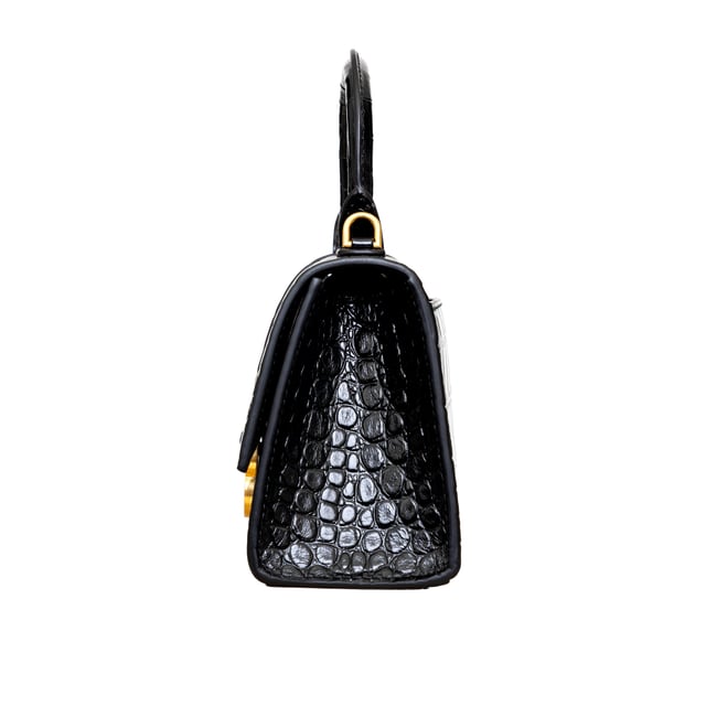 VINTAGE, RRP AS NEW
Crafted from black, shiny crocodile embossed calfskin, this Balenciaga handbag in XS format features the iconic curvilinear base, one top handle, and a studded magnet closure for a chic and modern touch. The aged-gold B logo hardware and nappa lambskin lining add a touch of sophistication, while the back and inner pockets and the removable shoulder strap make the bag more functional.
Inclusion: dust bag, shoulder strap.
NFT option available. Discover more.
Assured Product Authenticity: This product is supplied by a renowned and trusted partner.
With this purchase, you are preserving iconic craftsmanship, celebrating heritage, and embracing the beauty of conscious shopping.Measurments:  width: 165 mm length: 457 mm height: 300 mm handle drop: 165 mm