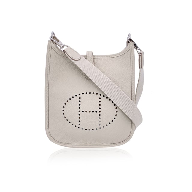 VINTAGE, RRP AS NEW
This beautiful Bag will come with a Certificate of ity provided by Entrupy. The certificate will be provided at no further cost.  Introducing the timeless elegance of the Hermes 'Mini Evelyne 16 Amazone' shoulder bag, crafted in sumptuous Togo leather. Originally designed by Evelyne Bertrand, Head of the Hermès Riding Department, in 1978, this iconic piece reflects the heritage and sophistication synonymous with the House of Hermes. The distinct perforated 'H' on the front serves as an unmistakable signature, while the fold-over strap closure and sleek, minimal design exude effortless luxury.  This mini version, with its versatile removable and adjustable shoulder strap, offers both style and practicality, perfect for daily wear or as a standout accessory for special occasions. The interior is lined in suede, maintaining the refined craftsmanship that Hermes is known for.  Stamped with 'Hermes Paris - Made in France' on leather and on the shoulder strap, the bag also bears the year of production 'W' (2024), discreetly embossed on the reverse of the leather closure strap.  Whether you're a long-time collector or a newcomer to Hermes, the 'Evelyne 16 Amazone' is a true testament to the brand's legacy of creating pieces that combine both function and fashion in a way only Hermes can. Condition Rating: A - EXCELLENTCondition Details: Gently used. Hermes dustbag included. Please check the photos carefully and ask if you need to know m ore details or if you have any doubts.Measurements (cm):Depth: 5.1Height: 17.8Length: 19.1Other Details: Dustbag? YesKeys? NoBox? No Measurments:  width: 51 mm length: 191 mm height: 178 mm