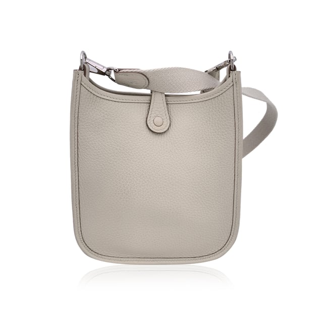 VINTAGE, RRP AS NEW
This beautiful Bag will come with a Certificate of ity provided by Entrupy. The certificate will be provided at no further cost.  Introducing the timeless elegance of the Hermes 'Mini Evelyne 16 Amazone' shoulder bag, crafted in sumptuous Togo leather. Originally designed by Evelyne Bertrand, Head of the Hermès Riding Department, in 1978, this iconic piece reflects the heritage and sophistication synonymous with the House of Hermes. The distinct perforated 'H' on the front serves as an unmistakable signature, while the fold-over strap closure and sleek, minimal design exude effortless luxury.  This mini version, with its versatile removable and adjustable shoulder strap, offers both style and practicality, perfect for daily wear or as a standout accessory for special occasions. The interior is lined in suede, maintaining the refined craftsmanship that Hermes is known for.  Stamped with 'Hermes Paris - Made in France' on leather and on the shoulder strap, the bag also bears the year of production 'W' (2024), discreetly embossed on the reverse of the leather closure strap.  Whether you're a long-time collector or a newcomer to Hermes, the 'Evelyne 16 Amazone' is a true testament to the brand's legacy of creating pieces that combine both function and fashion in a way only Hermes can. Condition Rating: A - EXCELLENTCondition Details: Gently used. Hermes dustbag included. Please check the photos carefully and ask if you need to know m ore details or if you have any doubts.Measurements (cm):Depth: 5.1Height: 17.8Length: 19.1Other Details: Dustbag? YesKeys? NoBox? No Measurments:  width: 51 mm length: 191 mm height: 178 mm