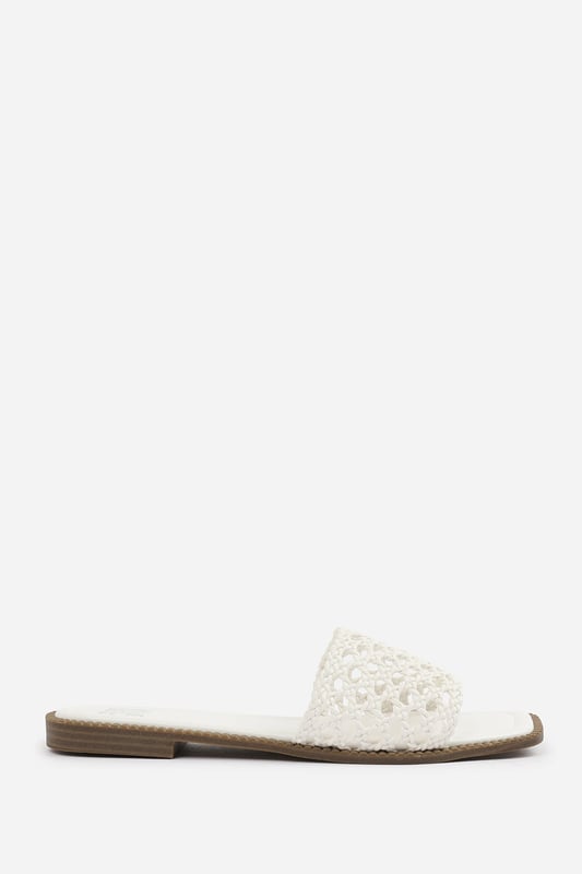 Wheres That From Womens 'Lottie' Woven Strap Flat Sandals Step into summer style with the Lottie Woven Strap Flat Sandals, crafted for both comfort and statement appeal. Featuring a metallic footbed and intricately braided upper, these sandals add a touch of luxe to any warm-weather look. Perfect for holidays, brunches, or day-to-night outfits. The open-toe, easy slip-on design makes them your go-to for effortless elegance. Key Features: • Material: Metallic faux leather with woven braided strap • Durability: Sturdy sole with cushioned footbed for all-day wear • Closure: Slip-on style for easy on and off convenience • Detail: Handcrafted-look open weave strap over a square toe base