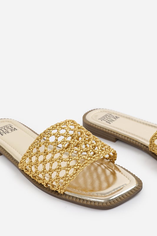 Wheres That From Womens 'Lottie' Women Strap Flat Sandals Step into summer style with the Lottie Woven Strap Flat Sandals, crafted for both comfort and statement appeal. Featuring a metallic footbed and intricately braided upper, these sandals add a touch of luxe to any warm-weather look. Perfect for holidays, brunches, or day-to-night outfits. The open-toe, easy slip-on design makes them your go-to for effortless elegance. Key Features: • Material: Metallic faux leather with woven braided strap • Durability: Sturdy sole with cushioned footbed for all-day wear • Closure: Slip-on style for easy on and off convenience • Detail: Handcrafted-look open weave strap over a square toe base