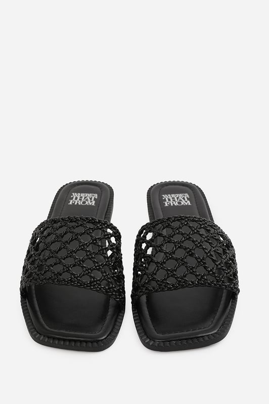 Wheres That From Womens 'Lottie' Woven Strap Flat Sandals Step into summer style with the Lottie Woven Strap Flat Sandals, crafted for both comfort and statement appeal. Featuring a metallic footbed and intricately braided upper, these sandals add a touch of luxe to any warm-weather look. Perfect for holidays, brunches, or day-to-night outfits. The open-toe, easy slip-on design makes them your go-to for effortless elegance. Key Features: • Material: Metallic faux leather with woven braided strap • Durability: Sturdy sole with cushioned footbed for all-day wear • Closure: Slip-on style for easy on and off convenience • Detail: Handcrafted-look open weave strap over a square toe base