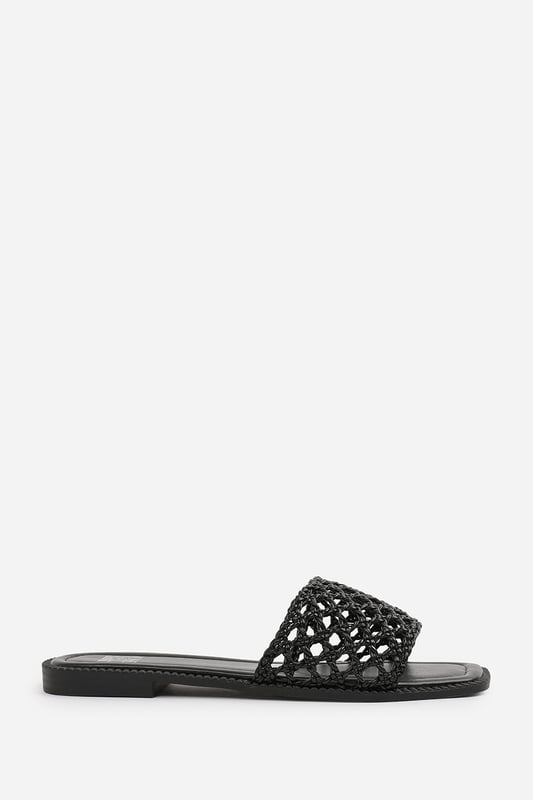 Wheres That From Womens 'Lottie' Woven Strap Flat Sandals Step into summer style with the Lottie Woven Strap Flat Sandals, crafted for both comfort and statement appeal. Featuring a metallic footbed and intricately braided upper, these sandals add a touch of luxe to any warm-weather look. Perfect for holidays, brunches, or day-to-night outfits. The open-toe, easy slip-on design makes them your go-to for effortless elegance. Key Features: • Material: Metallic faux leather with woven braided strap • Durability: Sturdy sole with cushioned footbed for all-day wear • Closure: Slip-on style for easy on and off convenience • Detail: Handcrafted-look open weave strap over a square toe base