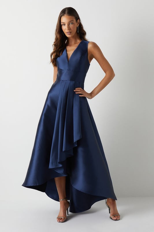 Elegant plunge neckline for a sophisticated look
        Sleeveless design perfect for warm-weather weddings
        Dramatic waterfall skirt with high-low hemline
        Fitted bodice accentuates the waistline
        Floor-sweeping maxi length for a graceful silhouette
    
    This stunning bridesmaids maxi dress from Coast is the epitome of elegance and grace. The plunging V-neckline adds a touch of allure, while the fitted bodice creates a flattering silhouette. The pice de rsistance is undoubtedly the waterfall skirt, which cascades beautifully to the floor, creating a mesmerising high-low effect. Perfect for a sophisticated bridal party, this dress will ensure you look and feel your best as you support the bride on her special day. Style with delicate strappy sandals and a sleek updo to complement the dress's clean lines. For a coordinated bridal party look, consider matching accessories such as pearl earrings or a dainty bracelet. This versatile piece will have you feeling confident and radiant as you celebrate love and new beginnings.