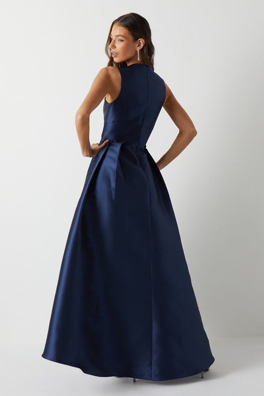 Elegant plunge neckline for a sophisticated look
        Sleeveless design perfect for warm-weather weddings
        Dramatic waterfall skirt with high-low hemline
        Fitted bodice accentuates the waistline
        Floor-sweeping maxi length for a graceful silhouette
    
    This stunning bridesmaids maxi dress from Coast is the epitome of elegance and grace. The plunging V-neckline adds a touch of allure, while the fitted bodice creates a flattering silhouette. The pice de rsistance is undoubtedly the waterfall skirt, which cascades beautifully to the floor, creating a mesmerising high-low effect. Perfect for a sophisticated bridal party, this dress will ensure you look and feel your best as you support the bride on her special day. Style with delicate strappy sandals and a sleek updo to complement the dress's clean lines. For a coordinated bridal party look, consider matching accessories such as pearl earrings or a dainty bracelet. This versatile piece will have you feeling confident and radiant as you celebrate love and new beginnings.