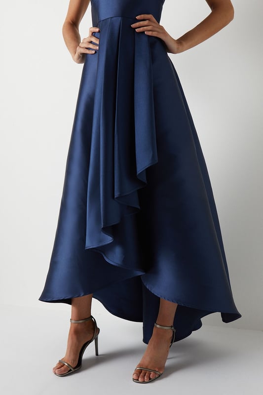 Elegant plunge neckline for a sophisticated look
        Sleeveless design perfect for warm-weather weddings
        Dramatic waterfall skirt with high-low hemline
        Fitted bodice accentuates the waistline
        Floor-sweeping maxi length for a graceful silhouette
    
    This stunning bridesmaids maxi dress from Coast is the epitome of elegance and grace. The plunging V-neckline adds a touch of allure, while the fitted bodice creates a flattering silhouette. The pice de rsistance is undoubtedly the waterfall skirt, which cascades beautifully to the floor, creating a mesmerising high-low effect. Perfect for a sophisticated bridal party, this dress will ensure you look and feel your best as you support the bride on her special day. Style with delicate strappy sandals and a sleek updo to complement the dress's clean lines. For a coordinated bridal party look, consider matching accessories such as pearl earrings or a dainty bracelet. This versatile piece will have you feeling confident and radiant as you celebrate love and new beginnings.