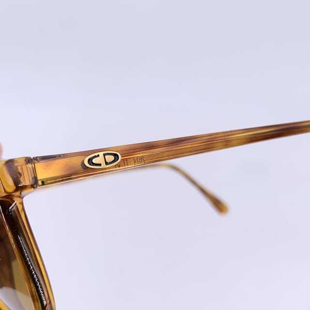 VINTAGE, RRP AS NEW
Infuse your look with vintage allure through these stunning Christian Dior CD 2614 sunglasses, a rare find from the fashion-forward 1980s. With their graceful classic and simple silhouette and warm brown tones, they embody the elegance and flair that defined Dior's golden age of accessories.  Made in Germany for women, this model is crafted from high-quality Lcm Optyl, offering both durability and a lightweight, comfortable fit. The 54 mm wide lenses and 42 mm height provide flattering coverage, while the 140 mm temples and temple-to-temple width create a balanced, secure wear perfect for everyday style or standout vintage looks.  Graded in A - EXCELLENT Condition Rating: A - EXCELLENTCondition Details: Gently Used. Lenses and frame in excellent condition. Please check the images carefully. Some show arrows indicating any evident defect. Please ask if you need to know more details or if you have any doubts. Generic case always included, please ask for availability of original case. Glasses maximum Width: 140mm Glasses Temple 130mm Glasses maximum lens width: 54mm Glasses maximum lens 42mm Glasses bridge width: 15mm Measurments:  width: 140 mm height: 42 mm
