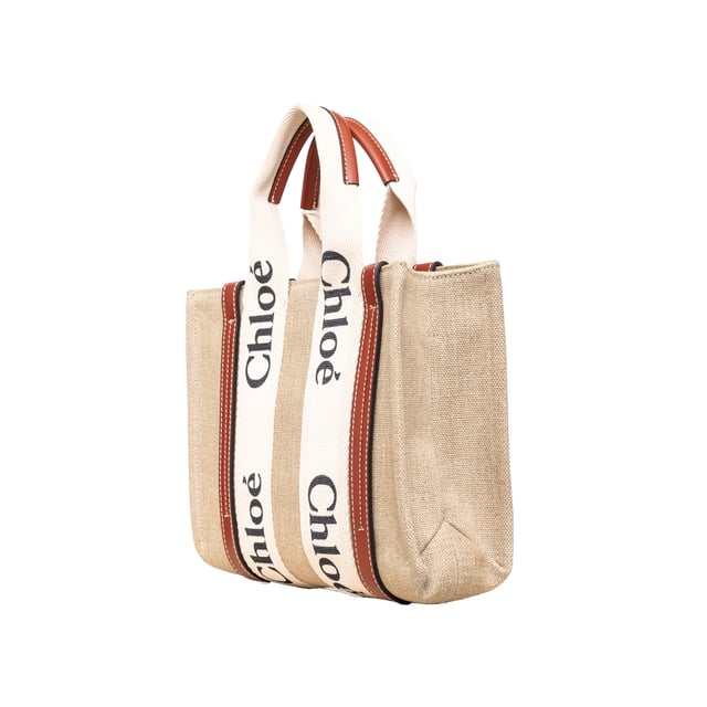 VINTAGE, RRP AS NEW
Effortlessly chic and environmentally conscious, the small Chloé Woody Tote Bag is crafted from lower-impact linen canvas and shiny brown calfskin strips. This compact bag features a roomy unlined interior with a practical leather shoulder strap and can be carried by top handles or as a crossbody on the shoulder.
Inclusion: dust bag, shoulder strap, authenticity card.
Assured Product Authenticity: This product is supplied by a renowned and trusted partner.
With this purchase, you are preserving iconic craftsmanship, celebrating heritage, and embracing the beauty of conscious shopping.Measurments:  width: 80 mm length: 260 mm height: 200 mm handle drop: 100 mm