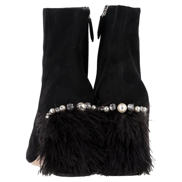 VINTAGE, RRP AS NEW
 The Miu Miu Feather Pearl-Embellished Ankle Boots in Black Suede are a captivating mix of drama and luxury, adorned with delicate pearls and soft feathers for a high-fashion finish. Crafted from plush suede, these boots offer a striking silhouette that effortlessly turns heads. Pair them with a sleek mini dress or tailored shorts to showcase their unique detailing and add a touch of avant-garde elegance to your look.

Miu Miu Feather Pear-Embellished Ankle Boots in Black Suede

Condition: Very good
Signs of wear: Minor markings, Lightly used but very well maintained. Minor mark at soles & creasing, light scuffing at the soles and heels.
Packaging: Dust bag
Color: Black
Material: Suede | suede
Size: IT | 39
Measurements: Heel height: 80; Insole length: 280
SKU: NAPPUGBSH489770W