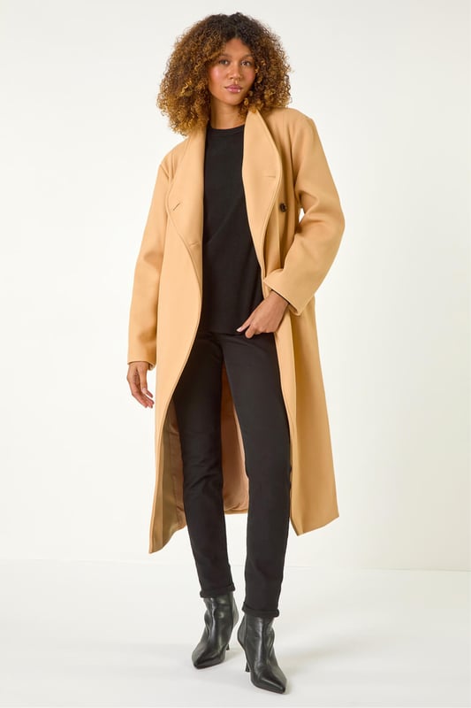 Asymmetric Double Breasted Tie Waist Coat from Roman. Wrap up in style this Autumn Winter with our fashionable, asymmetric double breasted coat. The unique asymmetric front and contrasting button fastenings add a modern touch to this classic coat silhouette. Featuring a tie waist belt detail for a flattering cinched-in look, this coat is crafted from a comfy woven fabric and fully lined for extra warmth. Finished with angled side pockets and long raglan sleeves, this coat is a must-have for your cold weather wardrobe. Pair with your favourite knit and ankle boots for a complete look!