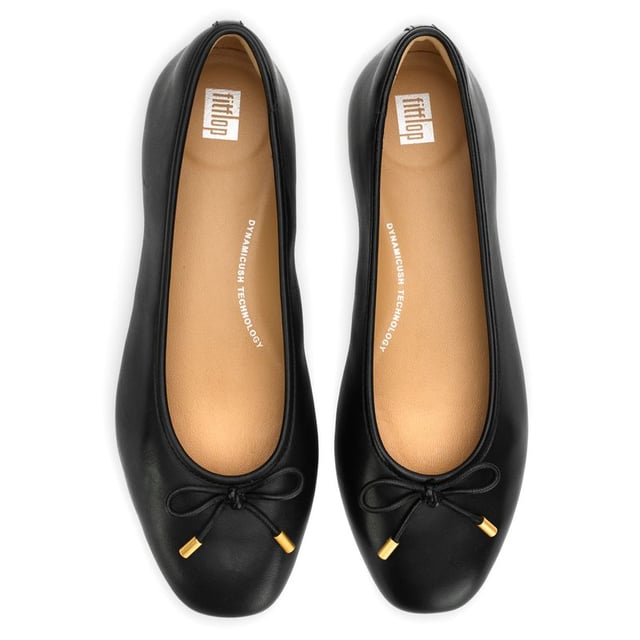 Fitflop Delicato Shoes The Delicato ballerina from Fitflop features a sleek modern square-toe silhouette and feels like a sneaker. Crafted in luxe butter-soft nappa leather, including a little bow, these delicate slip-ons are designed for an enhanced fit and are unbelievably comfortable, thanks to the supportive moulded footbeds and the signature Dynamicush cushioning soles. A light, slim, refined chic ballerina your feet will love.
