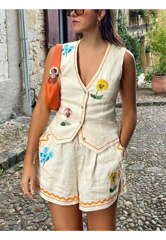 Two
  piece set
  Buttoned vest with V
  neck
  100% polyester
  Machine wash cold tumble dry low
  Imported
  Available in sizes S M L XL
  Top Length: S
  18.9 inches M
  19.3 inches L
  19.7 inches XL
  20.1 inches
  Bust: S
  33.9 inches M
  35.4 inches L
  37.8 inches XL
  40.2 inches
  Bottom Length: S
  12.6 inches M
  13 inches L
  13.4 inches XL
  13.8 inches
  Waist: S
  26.8 inches M
  28.3 inches L
  30.7 inches XL
  33.1 inches
Material: Linen Blend