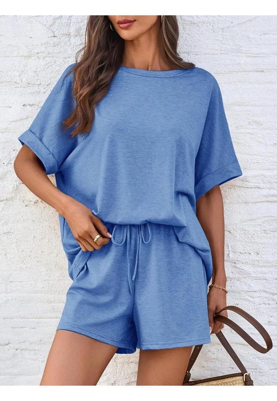 Basic style
  Two
  piece set
  No stretch
  95% polyester 5% spandex
  Machine wash cold tumble dry low
  Imported
  Size S: Bust 40.9 inches Top Length 24.8 inches Bottom Length 13.8 inches Waist 25.2 inches Hip 41.7 inches
  Size M: Bust 42.5 inches Top Length 25.2 inches Bottom Length 14.2 inches Waist 26.8 inches Hip 43.3 inches
  Size L: Bust 44.9 inches Top Length 25.6 inches Bottom Length 14.6 inches Waist 29.1 inches Hip 45.7 inches
  Size XL: Bust 47.2 inches Top Length 26 inches Bottom Length 15 inches Waist 31.5 inches Hip 48 inches
Material: The material appears to be a soft lightweight knit fabric possibly a blend of cotton and polyester.  The exact composition is .