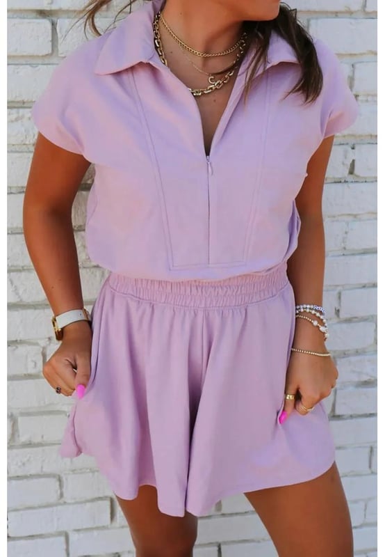 Short sleeve zipper collared elastic high waist romper
  Material composition: 50% polyester 45% viscose 5% elastane
  Care instructions: Machine wash cold. Tumble dry low
  Imported
  Available in sizes S M L XL
  Size S measurements: Top Length 33.4 inches Bust 38.2 inches Waist 26.8 inches Hip 43.3 inches Inseam 3.7 inches
  Size M measurements: Top Length 34.3 inches Bust 40.6 inches Waist 29.1 inches Hip 45.7 inches Inseam 3.7 inches
  Size L measurements: Top Length 35.1 inches Bust 42.9 inches Waist 31.5 inches Hip 48 inches Inseam 3.8 inches
  Size XL measurements: Top Length 36 inches Bust 46.1 inches Waist 34.6 inches Hip 51.2 inches Inseam 3.8 inches
