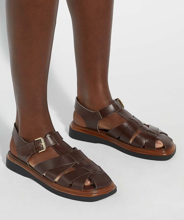 Lisherman redefines the classic beach sandal with its bold, contemporary design. Featuring a closed toe, adjustable ankle strap and a slight flatform sole for added lift, this chunky shoe combines style and comfort for a modern twist on a timeless classic.