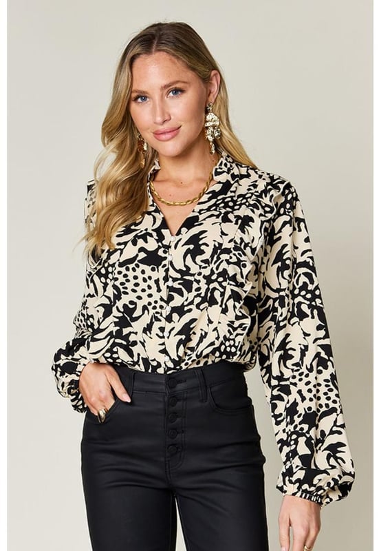 Buttoned front
  Ruffled trim
  Balloon sleeves
  Opaque material
  Made from 100% polyester
  Machine wash cold
  Tumble dry low
  Imported